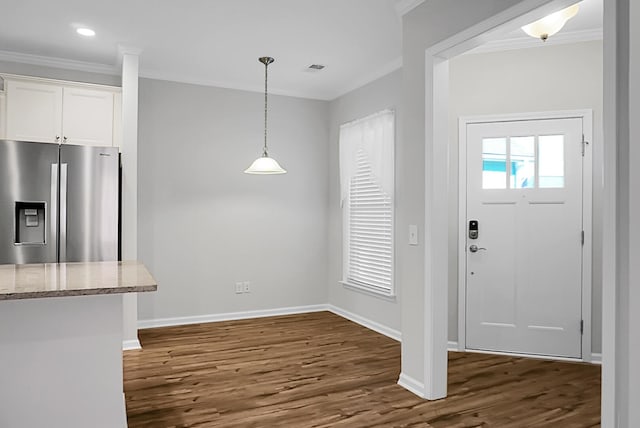 entryway with dark wood-type flooring and ornamental molding