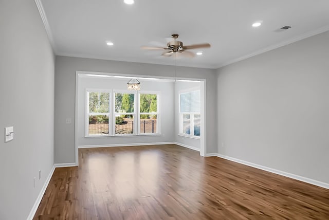 unfurnished room with ceiling fan with notable chandelier, dark hardwood / wood-style flooring, and crown molding