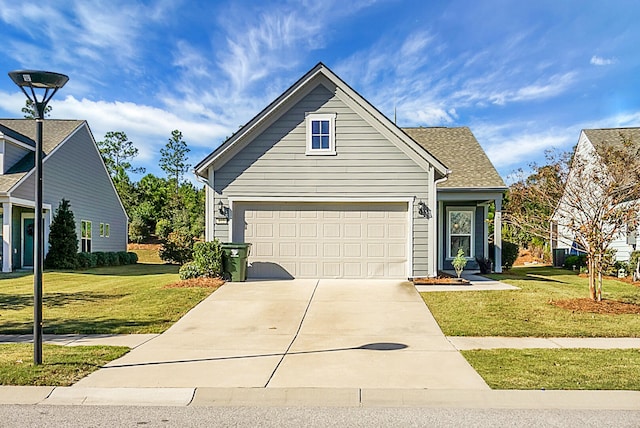 view of property featuring a garage and a front lawn