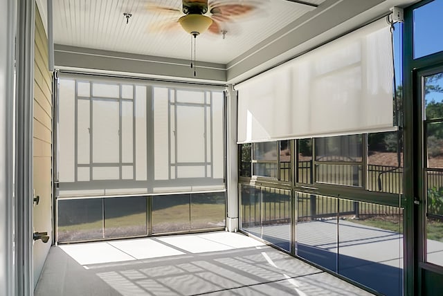 unfurnished sunroom with ceiling fan