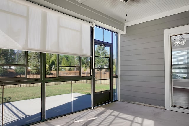 unfurnished sunroom with a chandelier