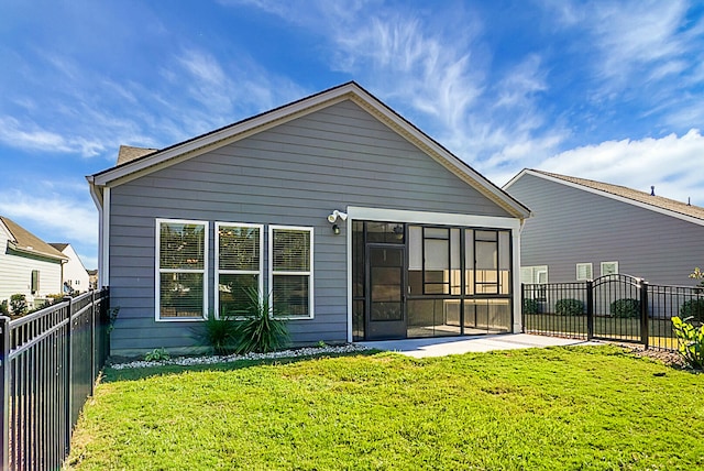 rear view of house featuring a lawn