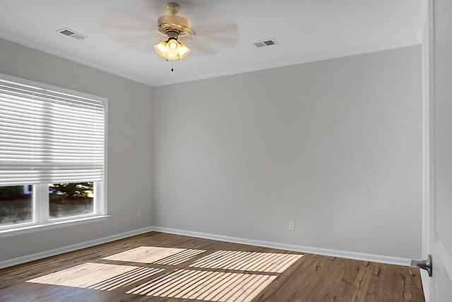 empty room with hardwood / wood-style floors, ceiling fan, and crown molding