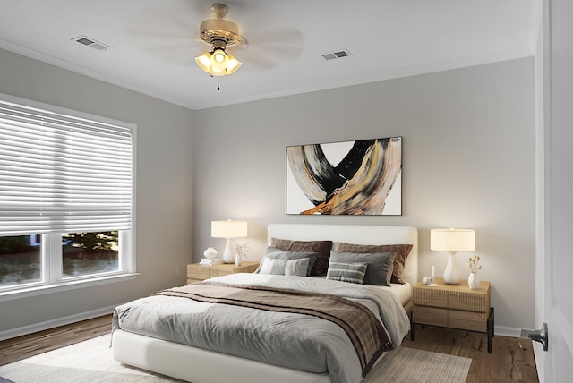 bedroom with ceiling fan, wood-type flooring, and ornamental molding