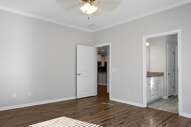 unfurnished bedroom with ceiling fan, dark hardwood / wood-style flooring, crown molding, and connected bathroom