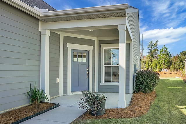 property entrance with a yard