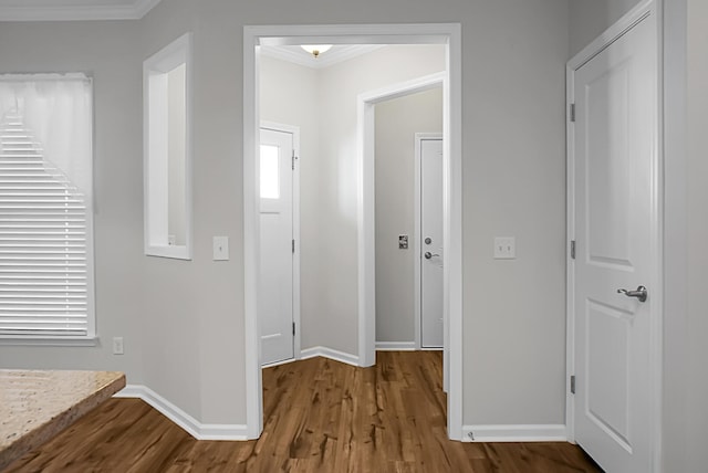 hall with hardwood / wood-style floors and ornamental molding