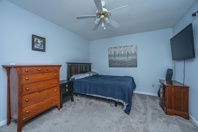 bedroom featuring ceiling fan, light carpet, and a textured ceiling