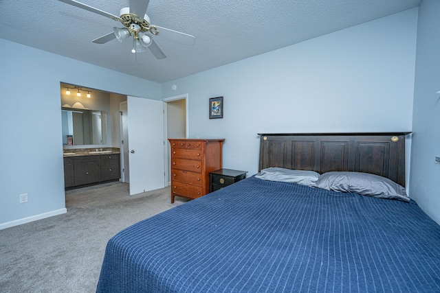 carpeted bedroom featuring ceiling fan, a textured ceiling, and ensuite bathroom