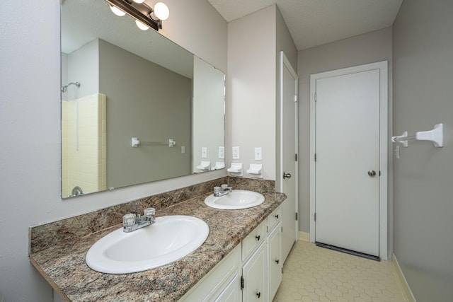 bathroom with vanity and a textured ceiling