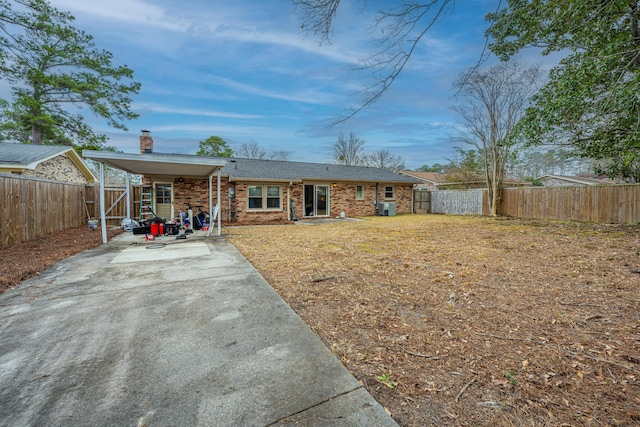 rear view of property with a carport