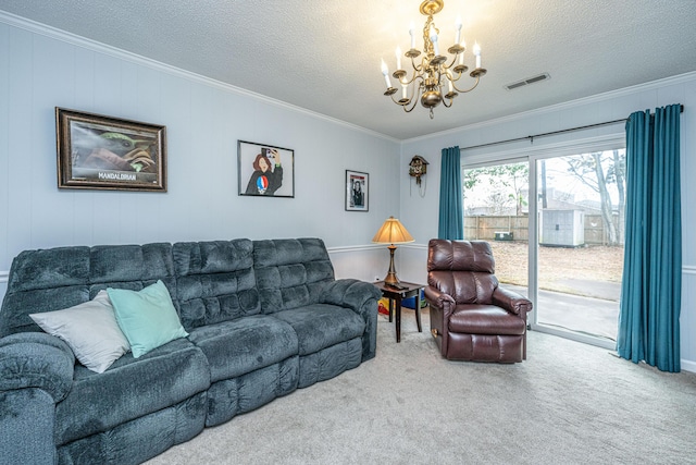 living room with ornamental molding, carpet flooring, a textured ceiling, and an inviting chandelier