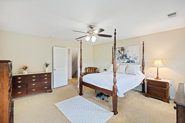 bedroom featuring light carpet and a ceiling fan