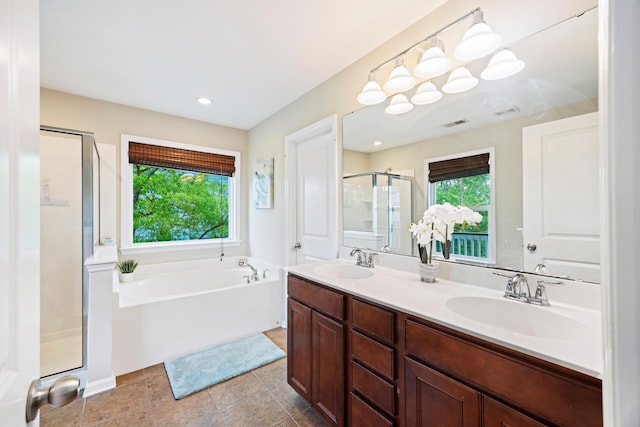 full bathroom with plenty of natural light, a stall shower, a garden tub, double vanity, and recessed lighting