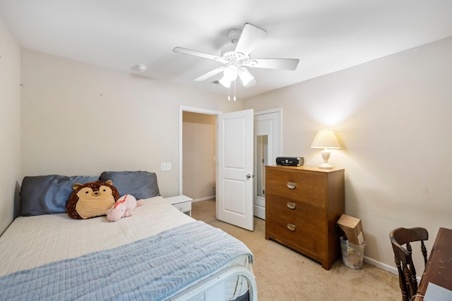 bedroom with light colored carpet, baseboards, and ceiling fan