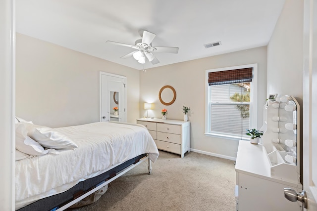 bedroom featuring light colored carpet, baseboards, and ceiling fan
