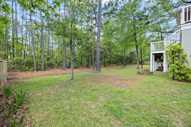 view of green lawn with a deck