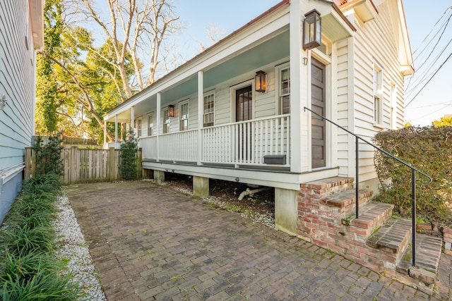 view of side of home with a porch