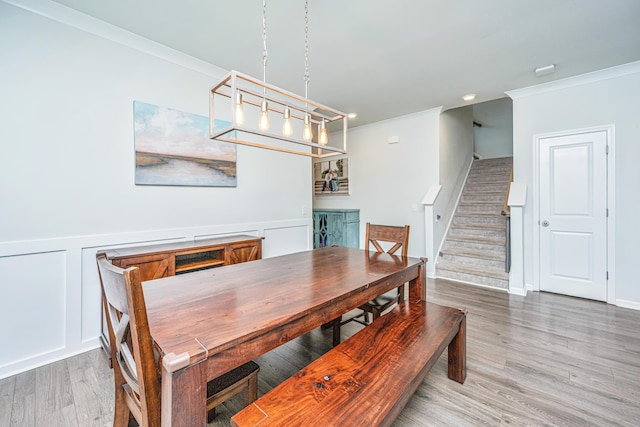 dining space with stairway, ornamental molding, recessed lighting, and wood finished floors