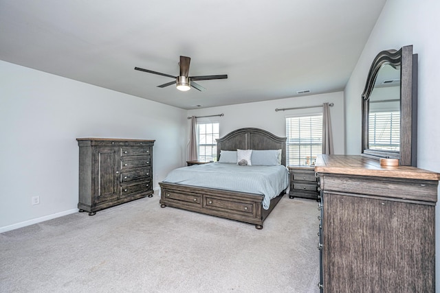 bedroom with light colored carpet, baseboards, ceiling fan, and visible vents