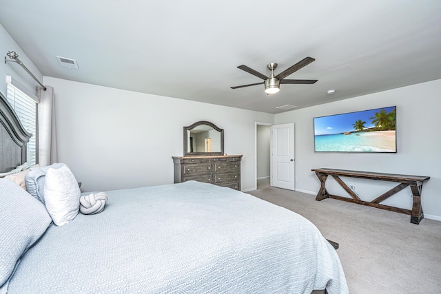 carpeted bedroom with baseboards, visible vents, and ceiling fan