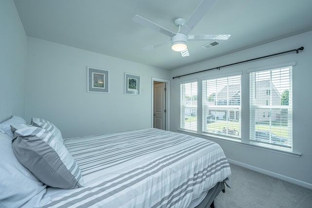 bedroom featuring visible vents, carpet, baseboards, and a ceiling fan