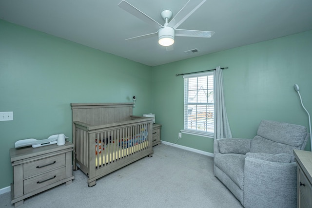 carpeted bedroom with a ceiling fan, baseboards, and visible vents