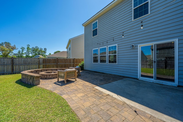 view of patio / terrace with a fire pit and a fenced backyard