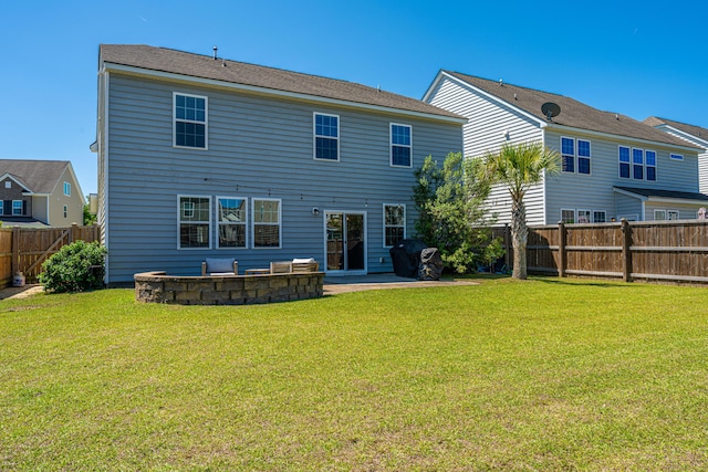 rear view of house featuring a fenced backyard, a patio area, and a yard