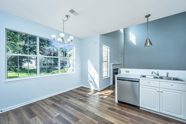 kitchen with pendant lighting, white cabinetry, sink, dark hardwood / wood-style flooring, and stainless steel dishwasher