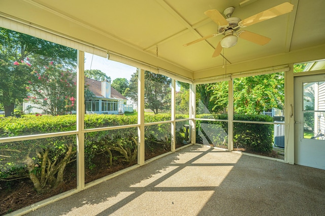 unfurnished sunroom with ceiling fan