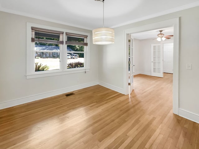 unfurnished dining area featuring ornamental molding, hardwood / wood-style floors, and ceiling fan