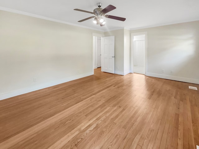 spare room featuring ornamental molding, light wood-type flooring, and ceiling fan