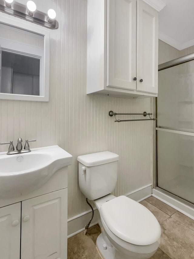 bathroom with vanity, a shower with shower door, toilet, and tile patterned flooring