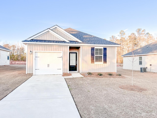 view of front of house with central AC unit and a garage