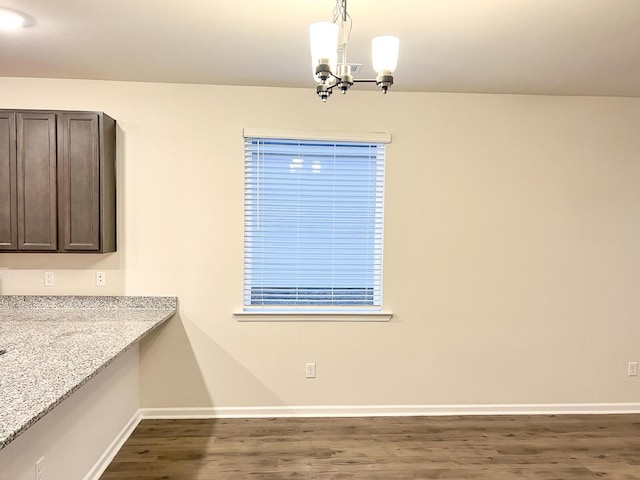 unfurnished dining area featuring a notable chandelier