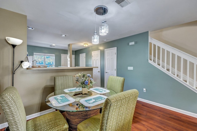 dining space with dark wood-type flooring