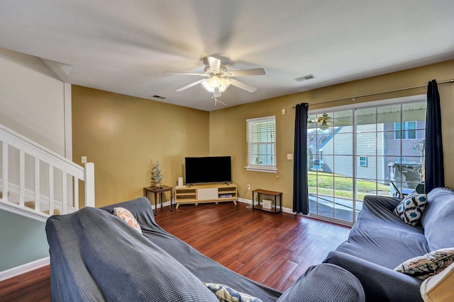 living room with dark hardwood / wood-style flooring and ceiling fan