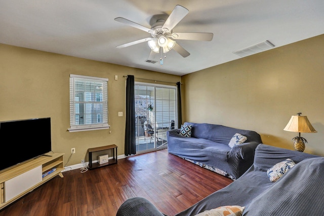 living room with ceiling fan and dark hardwood / wood-style flooring