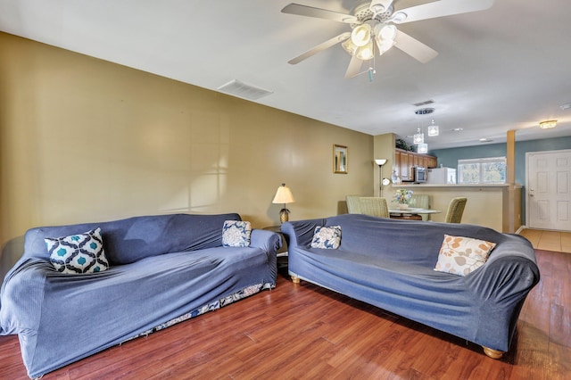 living room with ceiling fan and wood-type flooring