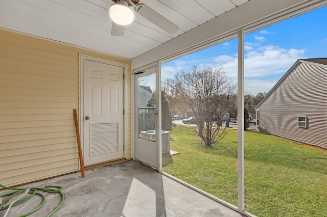 unfurnished sunroom with ceiling fan