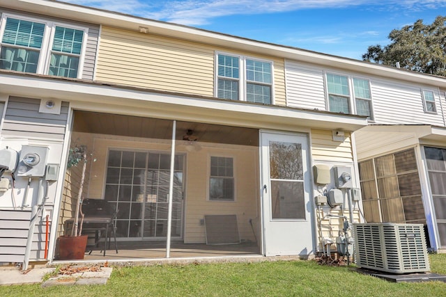 property entrance with a lawn and central air condition unit