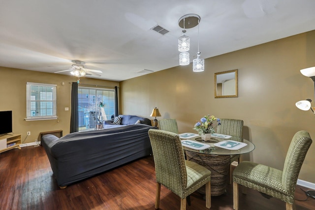 dining room with ceiling fan and dark hardwood / wood-style floors