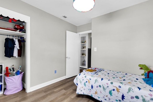 bedroom featuring hardwood / wood-style flooring and a closet