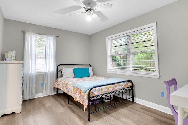 bedroom with light wood-type flooring and ceiling fan