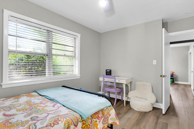 bedroom featuring ceiling fan and hardwood / wood-style flooring