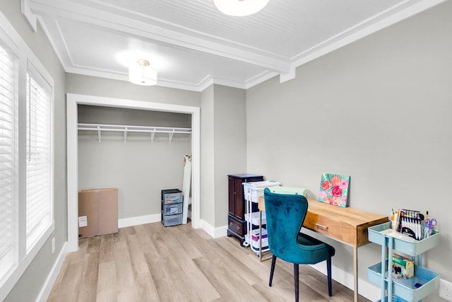 office area with light hardwood / wood-style floors and crown molding