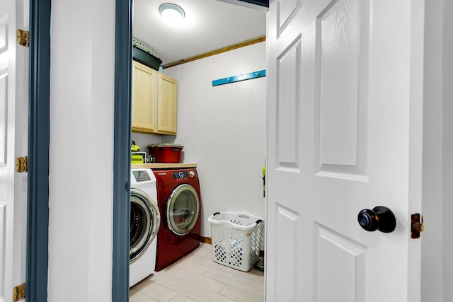 laundry room featuring cabinets and separate washer and dryer