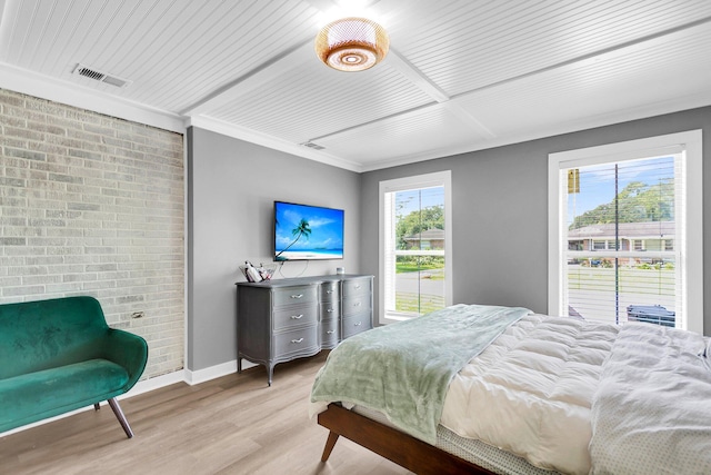 bedroom featuring light wood-type flooring and ornamental molding