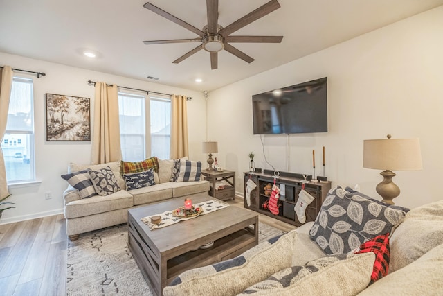 living room with ceiling fan and wood-type flooring